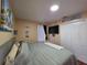 Bright bedroom with a ceiling light, closet, decorative elements and a cozy bed at 1104 Flamingo Dr, Leesburg, FL 34748