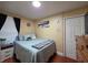 Comfortable bedroom with a cozy bed, soft lighting, and subtle coastal decor, creating a relaxing retreat at 1104 Flamingo Dr, Leesburg, FL 34748
