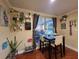 Cozy dining area featuring a dark wood table set, wood-look flooring, and charming decor at 1104 Flamingo Dr, Leesburg, FL 34748