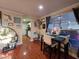 Cozy dining area features a dark table with seating for four, adjacent to the kitchen and a large window at 1104 Flamingo Dr, Leesburg, FL 34748