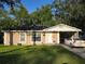 Charming single-story home featuring a well-maintained lawn and convenient carport at 1104 Flamingo Dr, Leesburg, FL 34748