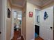 Hallway view of two bathrooms showcasing a neutral color palette and tile floors at 1104 Flamingo Dr, Leesburg, FL 34748