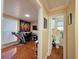 Hallway view showcasing tiled flooring leading to a bathroom and a versatile space with workout equipment at 1104 Flamingo Dr, Leesburg, FL 34748