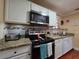 Well-equipped kitchen features granite counters, ample cabinetry, and modern appliances at 1104 Flamingo Dr, Leesburg, FL 34748