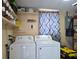 Well-organized laundry room with a washer and dryer, shelving and ample storage space at 1104 Flamingo Dr, Leesburg, FL 34748