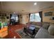 Living room features a cozy sectional sofa and large windows with views at 1104 Flamingo Dr, Leesburg, FL 34748