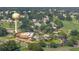 Community aerial view showcasing a pool, clubhouse, and golf course amidst lush trees at 1146 W Boone Ct, Lady Lake, FL 32159