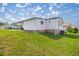 Expansive backyard with lush lawn featuring home's exterior and patio area at 1146 W Boone Ct, Lady Lake, FL 32159
