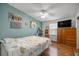 Comfortable bedroom with wood flooring, ceiling fan and view to outside at 1146 W Boone Ct, Lady Lake, FL 32159