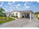 Inviting single-story home with a covered carport and meticulously maintained lawn at 1146 W Boone Ct, Lady Lake, FL 32159