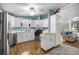 Bright kitchen featuring white cabinets, stainless steel appliances, and wood-look flooring at 1146 W Boone Ct, Lady Lake, FL 32159