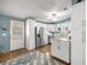 Bright kitchen featuring white cabinets, stainless steel appliances, a kitchen island and wood floors at 1146 W Boone Ct, Lady Lake, FL 32159