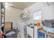 Functional laundry room with a washing machine, utility sink, and storage shelves at 1146 W Boone Ct, Lady Lake, FL 32159