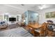 Open-concept living and dining area featuring hardwood floors and stylish decor at 1146 W Boone Ct, Lady Lake, FL 32159
