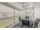 Cozy screened patio with a ceiling fan and table for outdoor dining and relaxation at 1146 W Boone Ct, Lady Lake, FL 32159