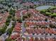 Aerial view featuring the property in a community with a nearby lake and golf course at 1202 Fernando Ln, The Villages, FL 32159