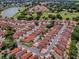 Aerial view showcasing the property nestled in a community near a golf course and lake at 1202 Fernando Ln, The Villages, FL 32159