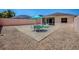 Backyard with a putting green and outdoor seating, with a view of the screened in lanai at 1202 Fernando Ln, The Villages, FL 32159