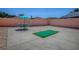 Backyard features a putting green, a concrete patio and a small table with four chairs at 1202 Fernando Ln, The Villages, FL 32159