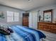 Bedroom showcasing blue striped bedding, light grey walls, and light wood-look vinyl plank flooring at 1202 Fernando Ln, The Villages, FL 32159