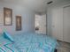 Bright bedroom with a geometric pattern bedspread, closet and connecting door to the living room at 1202 Fernando Ln, The Villages, FL 32159