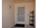 Inviting entryway with a secure screen door and decorative wrought iron details at 1202 Fernando Ln, The Villages, FL 32159