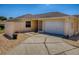 Charming home featuring a well-manicured lawn, inviting entrance, and a convenient two-car garage at 1202 Fernando Ln, The Villages, FL 32159