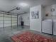 Spacious garage featuring a laundry area, with ample room for vehicles and storage at 1202 Fernando Ln, The Villages, FL 32159