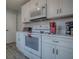 Bright kitchen featuring white cabinetry, modern appliances, and ample counter space at 1202 Fernando Ln, The Villages, FL 32159