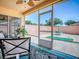 Enclosed lanai with access to the outdoor patio, which includes a putting green and patio furniture at 1202 Fernando Ln, The Villages, FL 32159