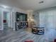 Inviting living room showcases modern furniture, a large television, and sliding glass doors to outdoor patio at 1202 Fernando Ln, The Villages, FL 32159