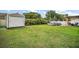 Large backyard featuring an above-ground pool, shed, and covered outdoor seating area; perfect for entertaining at 1204 Monterey Dr, Eustis, FL 32726