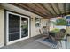 Covered patio with a seating area featuring outdoor furniture, BBQ, and an ice chest near sliding glass door at 1204 Monterey Dr, Eustis, FL 32726