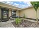 Charming home entrance featuring stylish chairs, decorative plants, and a welcoming glass paneled front door at 1204 Monterey Dr, Eustis, FL 32726