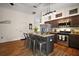 Well-equipped kitchen featuring an island with bar seating, stainless appliances, and stylish granite countertops at 1204 Monterey Dr, Eustis, FL 32726