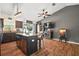 Modern kitchen with island seating, pendant lighting, stainless steel appliances, and seamless flow to living area at 1204 Monterey Dr, Eustis, FL 32726