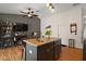 Open kitchen features granite counters, island with sink, and stainless steel appliances at 1204 Monterey Dr, Eustis, FL 32726
