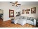 Comfortable living room showcasing hardwood floors and a large sectional couch with view of kitchen at 1204 Monterey Dr, Eustis, FL 32726