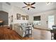 Inviting living room featuring hardwood floors and a modern ceiling fan, with access to entry door at 1204 Monterey Dr, Eustis, FL 32726