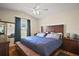 Comfortable main bedroom featuring a vaulted ceiling, dark wood furniture, and light-filled window at 1204 Monterey Dr, Eustis, FL 32726