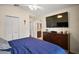 Bright main bedroom featuring a TV, closet, ceiling fan, and access to an en suite bathroom at 1204 Monterey Dr, Eustis, FL 32726