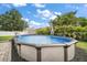 Enjoy a refreshing dip in this above ground pool surrounded by lush landscaping and a privacy fence at 1204 Monterey Dr, Eustis, FL 32726