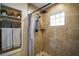 Tiled walk-in shower featuring a rainfall shower head and built-in niche at 1204 Monterey Dr, Eustis, FL 32726