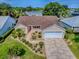 Aerial view of a single-story home featuring a well-manicured lawn and a two-car garage at 1206 Thompson Ave, The Villages, FL 32162