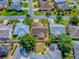 Aerial view of home with manicured lawn, mature trees, and a defined property line at 1206 Thompson Ave, The Villages, FL 32162