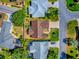 Overhead view of the property featuring a well-maintained lawn, landscaping, and nearby homes at 1206 Thompson Ave, The Villages, FL 32162