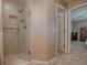 Modern walk-in shower with glass door, neutral colors, and tiled walls inside bathroom at 1206 Thompson Ave, The Villages, FL 32162
