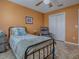 Comfortable bedroom with a ceiling fan, single bed, sliding closet, and comfortable armchair at 1206 Thompson Ave, The Villages, FL 32162