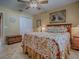 Spacious bedroom showcasing a ceiling fan, painted walls, and a tiled floor at 1206 Thompson Ave, The Villages, FL 32162