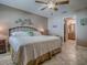 Bedroom features a comfortable bed, and a hallway view leading to a bathroom at 1206 Thompson Ave, The Villages, FL 32162